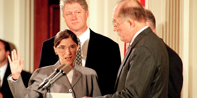 Supreme Court Chief Justice William Rehnquist, right, administers the oath to defend the Constitution to Ruth Bader Ginsburg as President Bill Clinton looks on in the East Room of the White House in Washington, D.C., Tuesday, Aug. 10, 1993. (AP Photo/Barry Thumma)