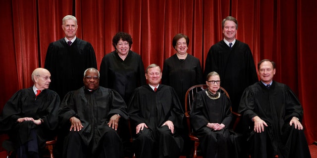 U.S. Supreme Court justices pose for their group portrait at the Supreme Court in Washington, U.S., November 30, 2018. Seated (L-R): Associate Justice Stephen Breyer, Associate Justice Clarence Thomas, Chief Justice of the United States John G. Roberts, Associate Justice Ruth Bader Ginsburg and Associate Justice Samuel Alito, Jr. Standing behind (L-R): Associate Justice Neil Gorsuch, Associate Justice Sonia Sotomayor, Associate Justice Elena Kagan and Associate Justice Brett M. Kavanaugh. REUTERS/Jim Young - RC1252A58870