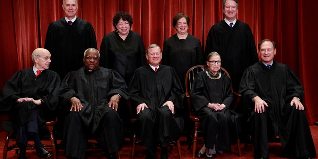 U.S. Supreme Court justices pose for their group portrait at the Supreme Court in Washington, U.S., November 30, 2018. Seated (L-R): Associate Justice Stephen Breyer, Associate Justice Clarence Thomas, Chief Justice of the United States John G. Roberts, Associate Justice Ruth Bader Ginsburg and Associate Justice Samuel Alito, Jr. Standing behind (L-R): Associate Justice Neil Gorsuch, Associate Justice Sonia Sotomayor, Associate Justice Elena Kagan and Associate Justice Brett M. Kavanaugh. REUTERS/Jim Young - RC1252A58870