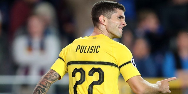 Borussia Dortmund's Christian Pulisic celebrates scoring his side's first goal during a Champions League group A soccer match between Club Brugge and Borussia Dortmund at the Jan Breydel Stadium in Bruges, Belgium.