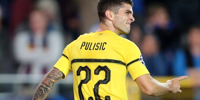 Borussia Dortmund's Christian Pulisic celebrates scoring his side's first goal during a Champions League group A soccer match between Club Brugge and Borussia Dortmund at the Jan Breydel Stadium in Bruges, Belgium.