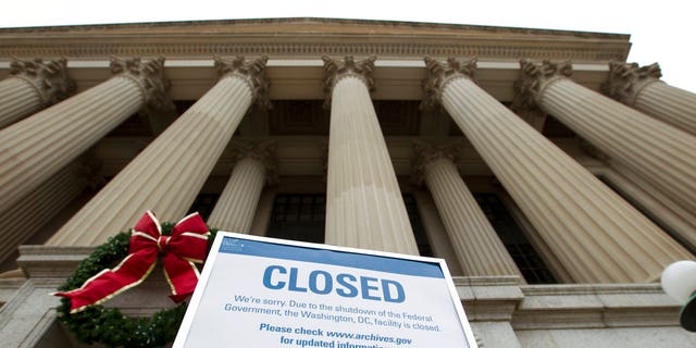 A closed sign is displayed at The National Archives entrance in Washington, Tuesday, Jan. 1, 2019, as a partial government shutdown stretches into its third week. A high-stakes move to reopen the government will be the first big battle between Nancy Pelosi and President Donald Trump as Democrats come into control of the House. (AP Photo/Jose Luis Magana)