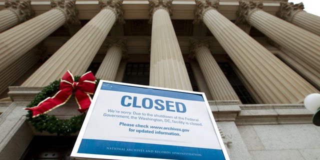 A closed sign is displayed at The National Archives entrance in Washington, Tuesday, Jan. 1, 2019, as a partial government shutdown stretches into its third week. A high-stakes move to reopen the government will be the first big battle between Nancy Pelosi and President Donald Trump as Democrats come into control of the House. (AP Photo/Jose Luis Magana)