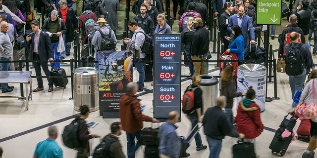 No-shows among screeners across the nation soared Sunday and again Monday, as TSA officers have been working without pay since the federal shutdown began Dec. 22. (John Spink/Atlanta Journal-Constitution via AP)