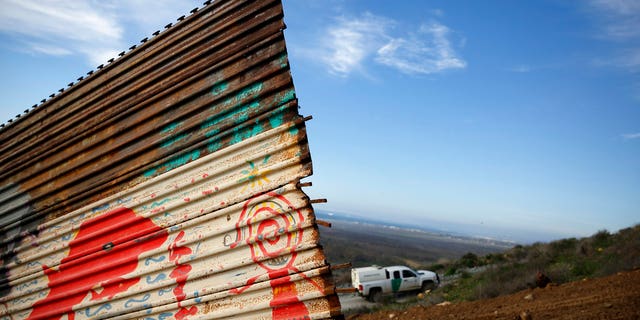 A U.S. Border Patrol vehicle passes behind a section of border wall Wednesday, Jan. 9, 2019, seen from Tijuana, Mexico. U.S. President Donald Trump walked out of his negotiating meeting with congressional leaders Wednesday — "I said bye-bye," he tweeted— as efforts to end the 19-day partial government shutdown fell into deeper disarray over his demand for billions of dollars to build a wall on the U.S.-Mexico border. (AP Photo/Gregory Bull)