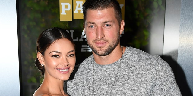 Miss Universe 2017 Demi-Leigh Nel-Peters and Tim Tebow of ESPN attend the Party At The Playoff at The GlassHouse on January 5, 2019.