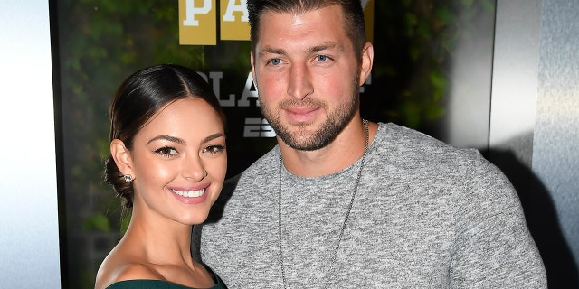 Miss Universe 2017 Demi-Leigh Nel-Peters and Tim Tebow of ESPN attend the Party At The Playoff at The GlassHouse on January 5, 2019.