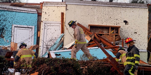 Rescue Workers search through damage after a tornado touchdown in Wetumpka, Ala., on Saturday, Jan. 19, 2019.