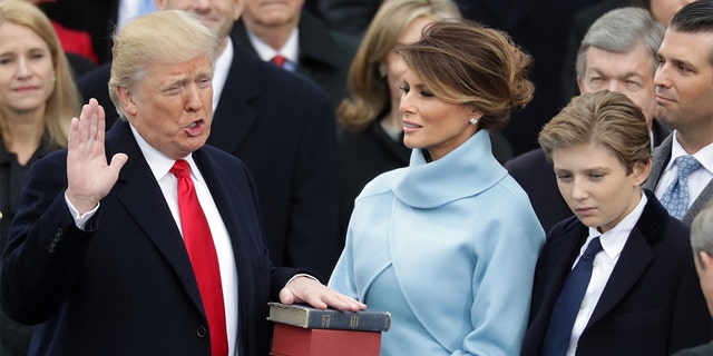 President Trump takes the oath of office as first lady Melania Trump holds the Bible with his son, Barron. (Photo by Chip Somodevilla/Getty Images)