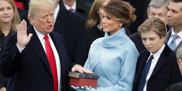 President Trump takes the oath of office as first lady Melania Trump holds the Bible with his son, Barron. (Photo by Chip Somodevilla/Getty Images)