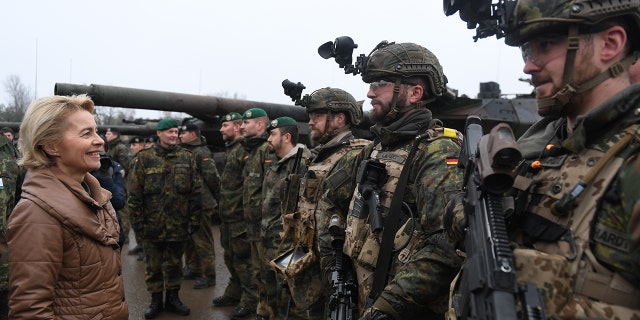 German Defense Minister Ursula von der Leyen chats with soldiers of the Bundeswehr during a visit to a Bundeswehr infantry training facility on December 6, 2018 in Munster, Germany.