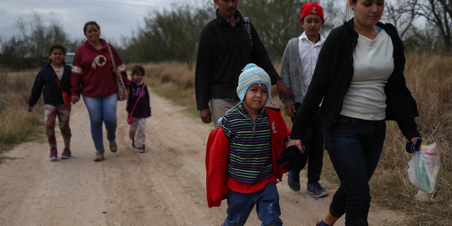 Migrant families from Central America seeking asylum walk down a dirt road after illegally crossing the Rio Grande into the U.S. from Mexico in Penitas, Texas, back in January. REUTERS/Adrees Latif - RC1AFBD3DDF0