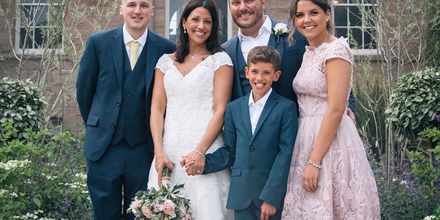 Lisa and Graeme Fox on their wedding day with her children, James, Hollie, and Jack.