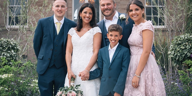 Lisa and Graeme Fox on their wedding day with her children, James, Hollie, and Jack.