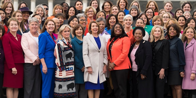 UNITED STATES - JANUARY 04: Speaker Nancy Pelosi, D-Calif., center, poses with Democratic women members of the House after a group photo on the East Front of the Capitol on January 4, 2019. (Photo By Tom Williams/CQ Roll Call)