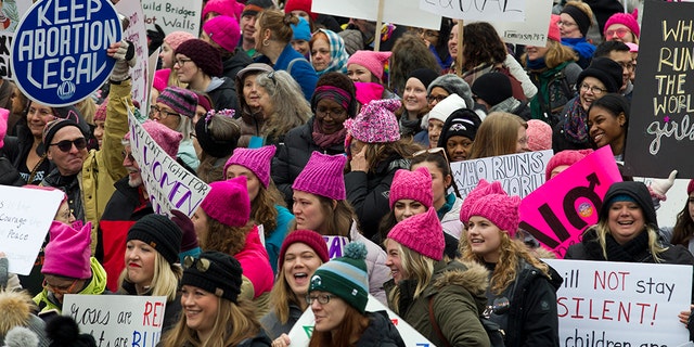 Demonstrators hold up their banners as they march on Pennsylvania Avenue during the Women's March in Washington on Saturday.