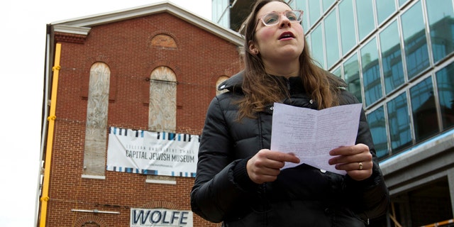 Rabbi Hannah Spiro of Hill Havurah offers a traditional Jewish traveler's prayer, before workers move the Adas Israel Synagogue, the oldest synagogue in Washington, to a new location, which will be part of the new Capital Jewish Museum on Wednesday, Jan. 9, 2019, in Washington . (AP Photo/Jose Luis Magana)