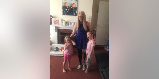 Dionne Brown, 26, who had her leg amputated to fight off cancer just months after giving birth to twins, is pictured with daughters Teigan, 6, and Halie, 4.