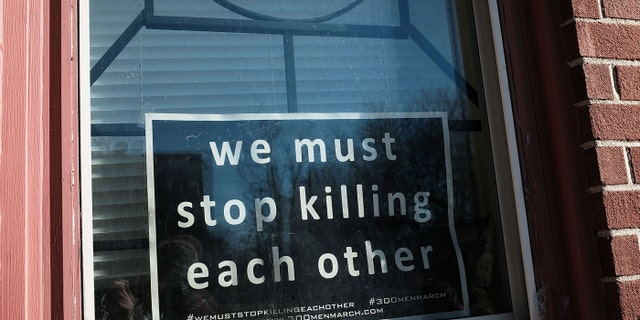 BALTIMORE, MD - FEBRUARY 03: A sign to end violence sits in a window in a neighborhood with a high murder rate on February 3, 2018 in Baltimore, Maryland.