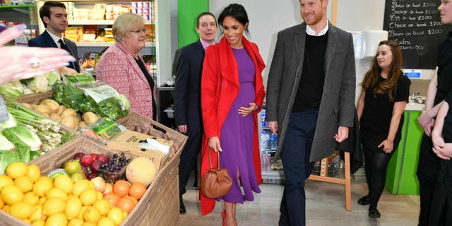 Britain's Prince Harry and Meghan, Duchess of Sussex officially open Number 7, a 'Feeding Birkenhead' citizens supermarket and community cafe, at Pyramids Shopping Centre, as part of a visit to Birkenhead, northwest England, Monday Jan. 14, 2019. (Anthony Devlin/Pool via AP)