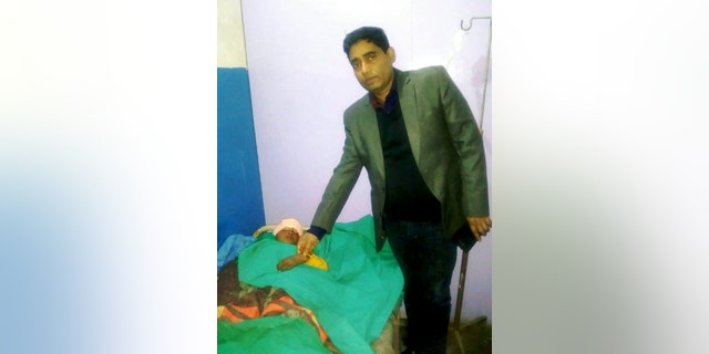 Dr. Chandra, pictured with Chhabila, said a CT scan revealed the bolt stopped just millimeters from the boy's brain.