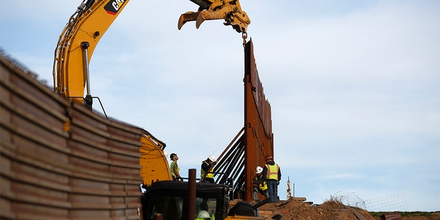 Workers replace sections of the border wall, left, with new sections, right, on Tuesday in Tijuana, Mexico.