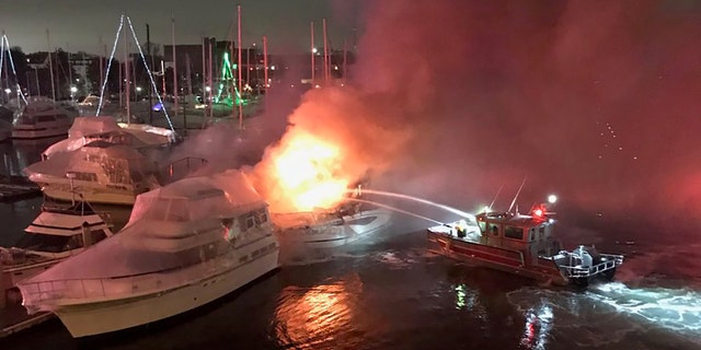 Two boats sank after three vessels caught fire late Tuesday at a Boston marina, officials said. (Boston Fire Department)
