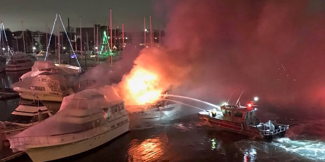 Two boats sank after three vessels caught fire late Tuesday at a Boston marina, officials said. (Boston Fire Department)