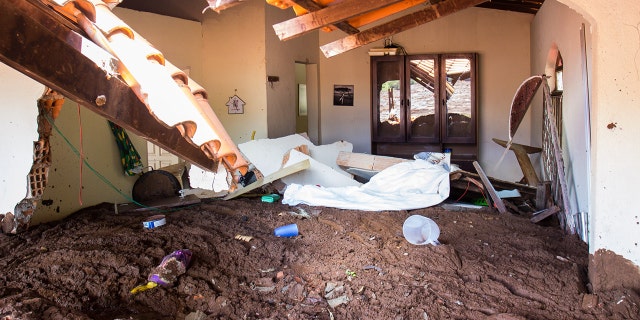 Drying mud lies high in a house affected by the mud avalanche caused by the broken dam. (Photo by Rodney Costa/picture alliance via Getty Images)
