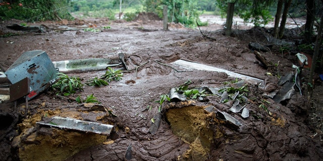 The mud covers the backyard of a house after a dam collapse near Brumadinho, Brazil, Saturday, Jan. 26, 2019.(Associated Press)