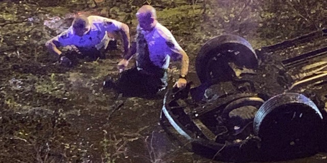Hillsborough County deputies in Florida rescued a woman who called 911 after flipping her car into "water and muck" off Interstate 4.