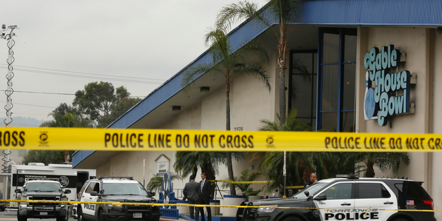 Police officers investigate a shooting incident with multiple fatalities at the Gable House Bowl in Torrance, Calif., Saturday, Jan. 5, 2019. A brawl between two large groups at the popular Los Angeles-area bowling alley and karaoke bar erupted into gunfire early Saturday according to witnesses. (AP Photo/Damian Dovarganes)