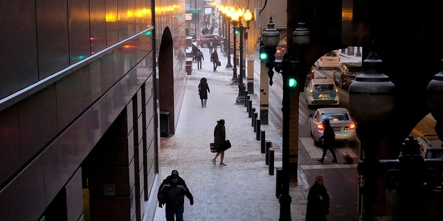 People brave frigid conditions while making their ways around a train station, Friday, Jan. 25, 2019, in downtown Chicago.