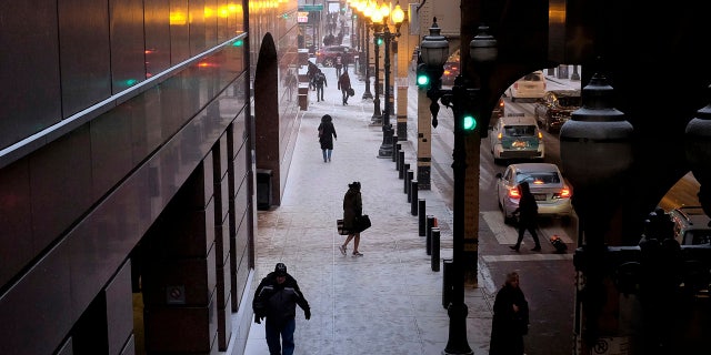 People brave frigid conditions while making their ways around a train station, Friday, Jan. 25, 2019, in downtown Chicago.