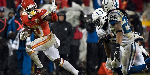 Kansas City Chiefs wide receiver Tyreek Hill (10) gestures as he runs past Indianapolis Colts safety Clayton Geathers (26) and linebacker Anthony Walker during the second half of an NFL divisional football playoff game in Kansas City, Mo., Saturday, Jan. 12, 2019. (Associated Press)