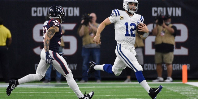 Indianapolis Colts quarterback Andrew Luck (12) runs as Houston Texans free safety Tyrann Mathieu (32) peruses during the second half of an NFL wild card playoff football game, Saturday, Jan. 5, 2019, in Houston. (Associated Press)