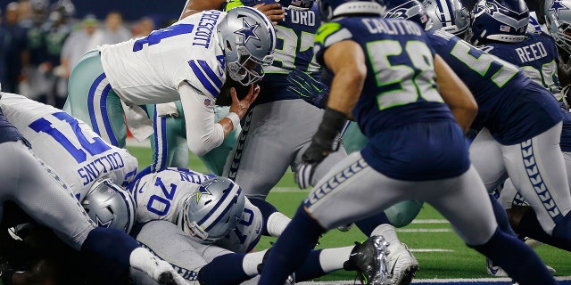 Dallas Cowboys quarterback Dak Prescott (4) runs into the end zone for a touchdown against the Seattle Seahawks during the second half of the NFC wild-card NFL football game in Arlington, Texas, Saturday, Jan. 5, 2019. (Associated Press)