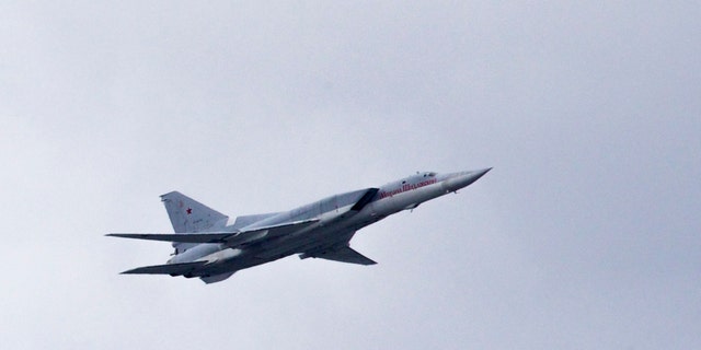 FILE - In this Thursday, May 5, 2016 file photo, a Russian Tu-22 bomber flies over Moscow's Kremlin during a general rehearsal for the Victory Day military parade which will take place at Moscow's Red Square on May 9 to celebrate 71 years after the victory in WWII in Moscow, Russia. The Russian military says that one of its long-range bombers has crash-landed in the Arctic, Tuesday Jan. 22, 2019, killing two of its crew of four. (AP Photo/Ivan Sekretarev, File)