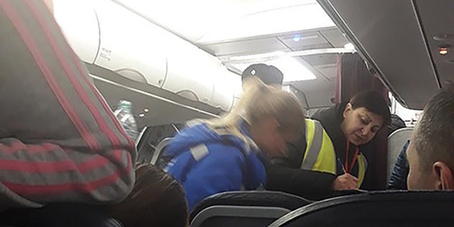 At least five passengers reported feeling ill during the flight.