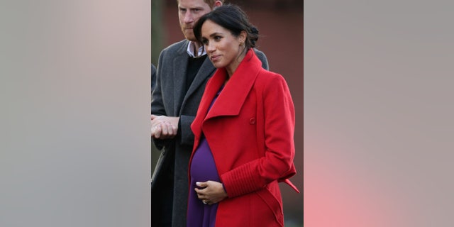 Meghan, the Duchess of Sussex and Britain's Prince Harry visit a new sculpture in Hamilton Square to mark the 100th anniversary of war poet Wilfred Owen's death, during a visit to Birkenhead, England, Monday, Jan. 14, 2019. (Aaron Chown/PA via AP)
