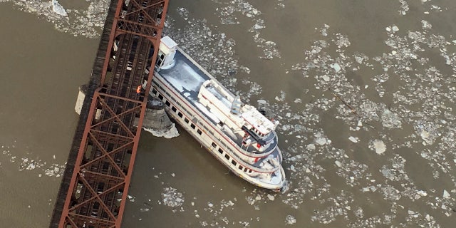 The Captain JP III cruise ship is wedged against the Livingston Avenue train bridge that spans the Hudson River, Friday, Jan. 25, 2019 in Albany, N.Y.