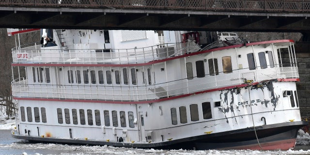Captain JP III cruise ship is wedged against the Livingston Avenue train bridge that spans the Hudson River in Albany, N.Y., Friday, Jan. 25, 2019.