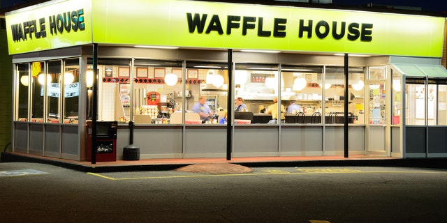 A couple took their love for Waffle House to an extreme at their wedding – by having a cake modeled to look like the façade of the restaurant.