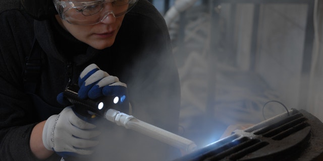 Margrit Bormann during conservation of a metal element from one of the crematoria