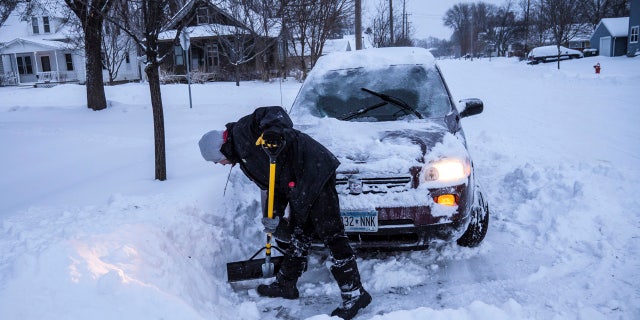 Adam Fischer shovels out his vehicle to go to work Monday, Jan. 28, 2019, in Rochester, Minn.