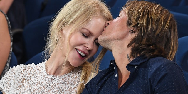 Nicole Kidman and Keith Urban share an affectionate moment at the Rod Laver Arena as they attend the 2019 Australian Open at Melbourne Park on January 24, 2019 in Melbourne, Australia.