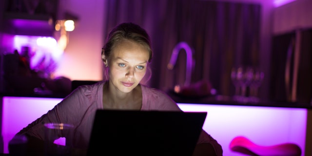 Woman burning the midnight oil - staying up late do get some work done on her computer. File photo.