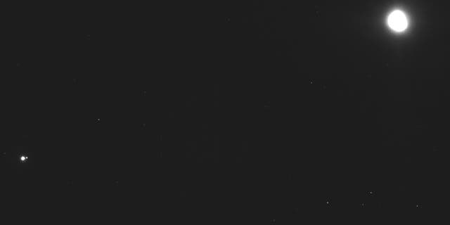 This image captured on Dec. 19, 2018, by a camera on the Osiris-Rex spacecraft shows the asteroid Bennu, top right, about 27 miles (43 kilometers) from the spacecraft, and the Earth and moon, bottom left, more than 70 million miles (110 million kilometers) away. Bennu, just 1,600 feet (500 meters) across, is the smallest celestial body ever to be orbited by a spacecraft. (NASA/Goddard/University of Arizona/Lockheed Martin Space via AP)