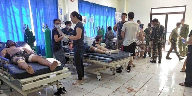 Bomb victims receive treatment in a hospital after two bombs exploded outside a Roman Catholic cathedral in Jolo, the capital of Sulu province in southern Philippines where militants are active Sunday, Jan. 27, 2019. (WESMINCOM Armed Forces of the Philippines Via AP)