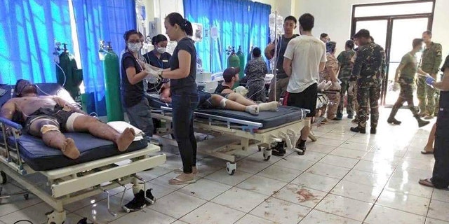 Bomb victims receive treatment in a hospital after two bombs exploded outside a Roman Catholic cathedral in Jolo, the capital of Sulu province in southern Philippines where militants are active Sunday, Jan. 27, 2019. (WESMINCOM Armed Forces of the Philippines Via AP)